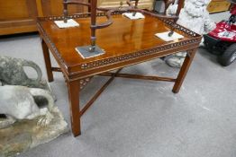 A reproduction mahogany coffee table having pierced gallery