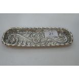 A heavily decorative Victorian silver American long trinket tray. Foiate scrolls and floral detailin