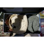 A case containing handbags and hats