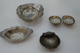 A very decorative lot comprising of a pair of silver shell trinket dishes, London 1894, on three bal