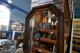 A 1920's Oak framed mirror with floral decorated glass and a painting of shoreline with lighthouse
