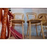 A vintage cane armchair and two Bentwood cafe chairs