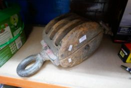 A large vintage wooden block possibly maritime, with metal hoops