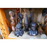 A selection of tribal carved figures, busts, etc