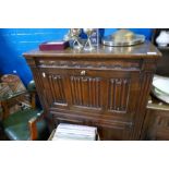 A repro oak cocktail cabinet and similar oak dresser with rack back