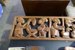 A large African carving of figures working and two other smaller examples