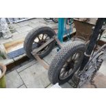 Pair of vintage wheels with pipe laying cradle