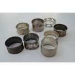 A quality of napkin rings to include silver examples and some plated. Some having engine turned desi