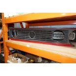 Three vintage car grills including a VW Golf example