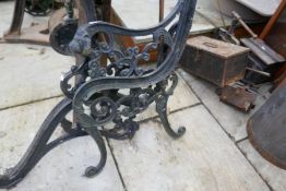A pair of cast iron lion headed bench ends