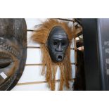 A selection of various tribal masks from around the World, all wooden and carved