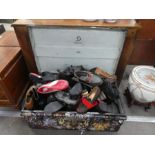 A metal trunk containing large quantity of shoes
