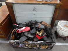 A metal trunk containing large quantity of shoes