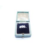 Antique diamond trilogy ring, with 3 round cut diamonds central diamond approx 0.5 carat, marked PLA