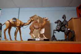 A bronze style figure of soldier on horseback and two Camel figures