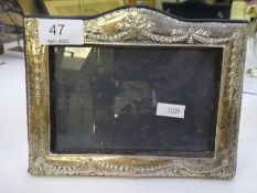 A pretty silver rectangular photoframe with bow decorated border, by BSC Ltd., navy velvet and easel