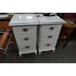 A pair of painted pine 3 drawer bedside chests, having plaster decoration