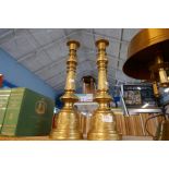 A pair of modern brass Altar style candlesticks having engraved decoration