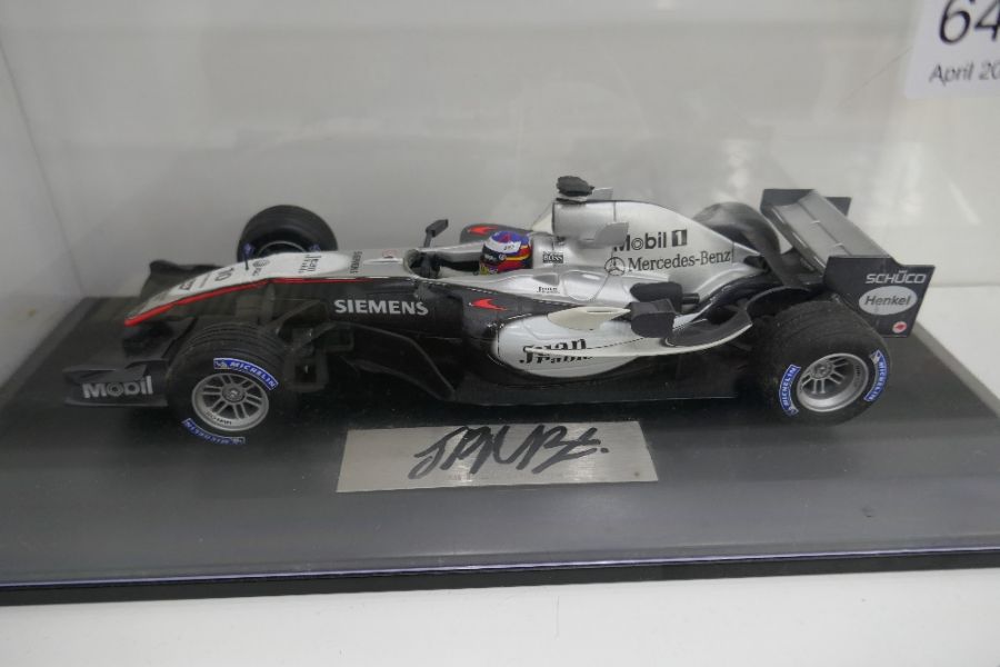 A model of a McLaren F1 car, signed by Juan Pablo Montoya, 1:18 scale, in case - Image 2 of 3