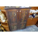 An early 20th Century Pokerwork Pine cupboard having four decorated panels of birds, trees and flowe