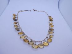 Yellow metal necklace hung with 22 oval mixed cut citrines unmarked, 24.78g approx