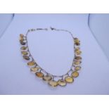 Yellow metal necklace hung with 22 oval mixed cut citrines unmarked, 24.78g approx