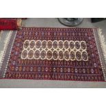 A modern Bokhara having two rows of elephant pads, and three smaller rugs (4)