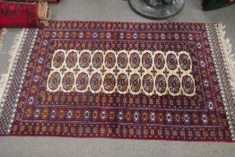 A modern Bokhara having two rows of elephant pads, and three smaller rugs (4)