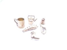Six 9ct yellow gold charms to include harp, kettle, carp, ice skate, cup and bell, all marked, 6.48g