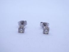Pair of 18ct white gold diamond stud earrings, each approx 0.10 carat, marked 750