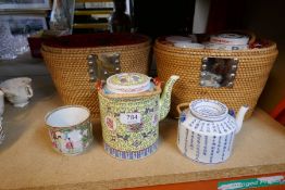 Three various Chinese teapots, with fitted wicker cases, and sundry