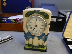 A modern Moorcroft mantle clock decorated blue flowers