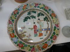A 19th Century Chinese circular dish decorated two figures, with floral border, 34.5cm