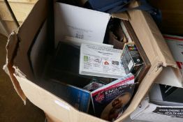 A box of mixed items including books and a brass table top