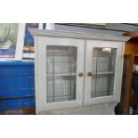 A grey painted kitchen dresser with glazed rackback