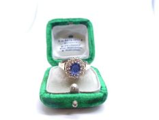 18ct yellow gold sapphire and diamond cluster ring with central mixed cut blue sapphire surrounded 1