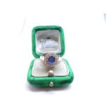 18ct yellow gold sapphire and diamond cluster ring with central mixed cut blue sapphire surrounded 1