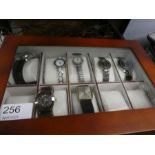 A modern watch box containing 7 fashion watches, various examples including Limit