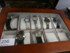 A modern watch box containing 7 fashion watches, various examples including Limit