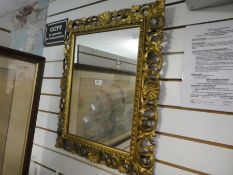An old gilt florentine wall mirror having pierced carved wood frame, 54.5 x 68cms