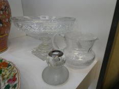 An old oval cut glass bowl on square foot, a vesta stand with silver collar and a brass jug