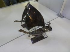 A model boat, silver however no marks seen. A very decorative piece with detailing, attachments on t