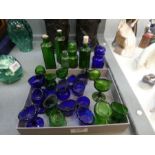 A quantity of old blue and green glass eye baths and sundry Poison bottles