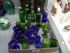A quantity of old blue and green glass eye baths and sundry Poison bottles