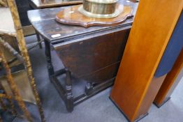 An antique oak gateleg table and an antique oak side table with shaped frieze