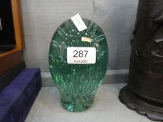 A large Victorian green glass dump paperweight
