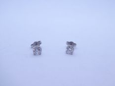 Pair 18ct white gold stud earrings, both round brilliant cut each approx 0.25, marked 750 with butte