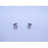 Pair 18ct white gold stud earrings, both round brilliant cut each approx 0.25, marked 750 with butte