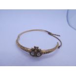 Antique 15ct yellow gold hinged bangle with sweetheart motif inset with seed pearls, the top with fl
