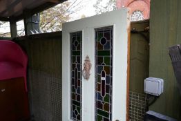 A painted 1920 door having leaded glass panels and a quantity of wrought iron supports with twisted